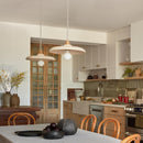 Modern kitchen with white cabinets, stainless steel appliances, and wooden dining table.