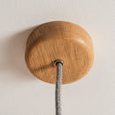 Wooden ceiling rose with a cable on a plain background