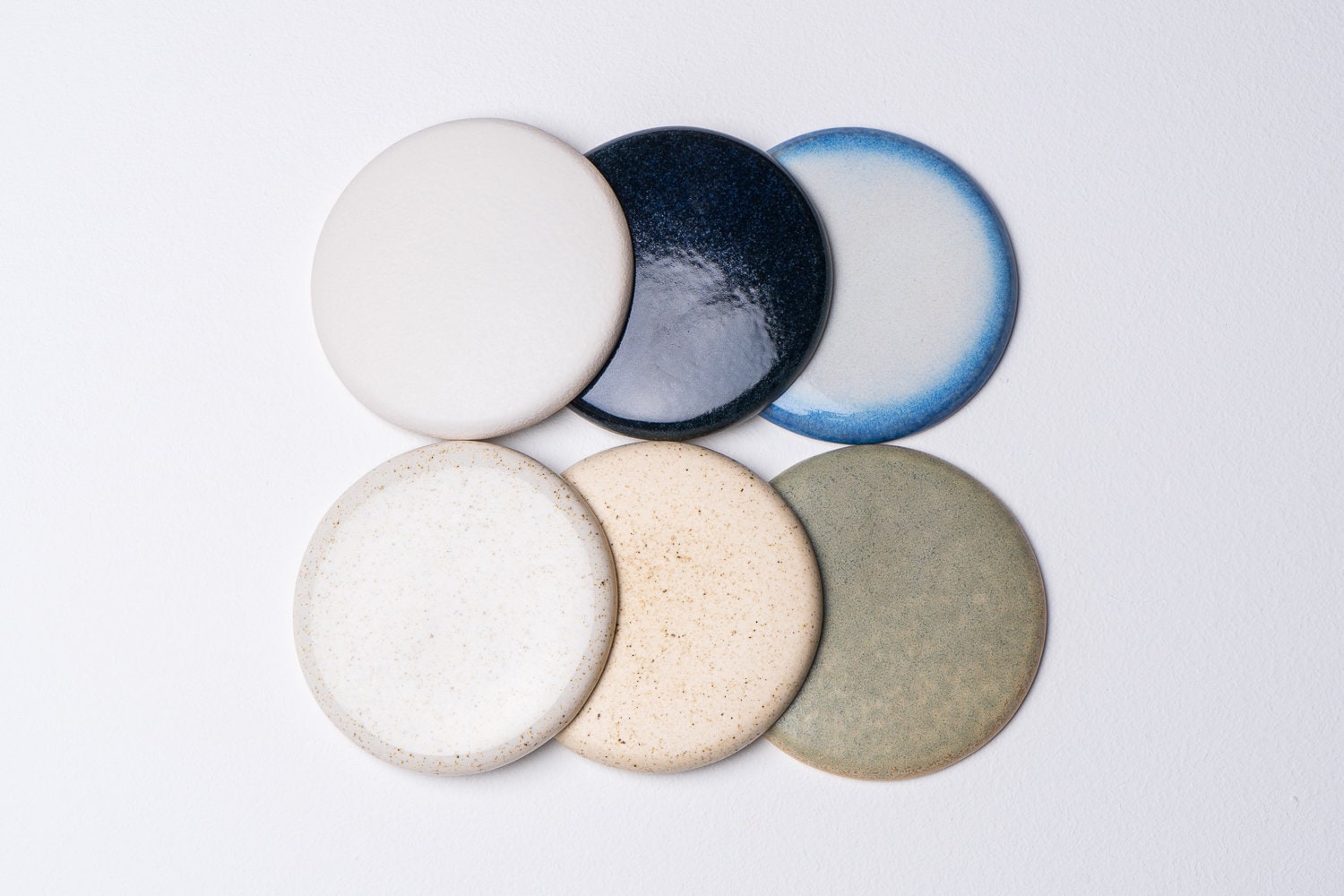 Element flush mount ceiling light in ceramic and oak with a blue and white gloss glaze by StudioHaran