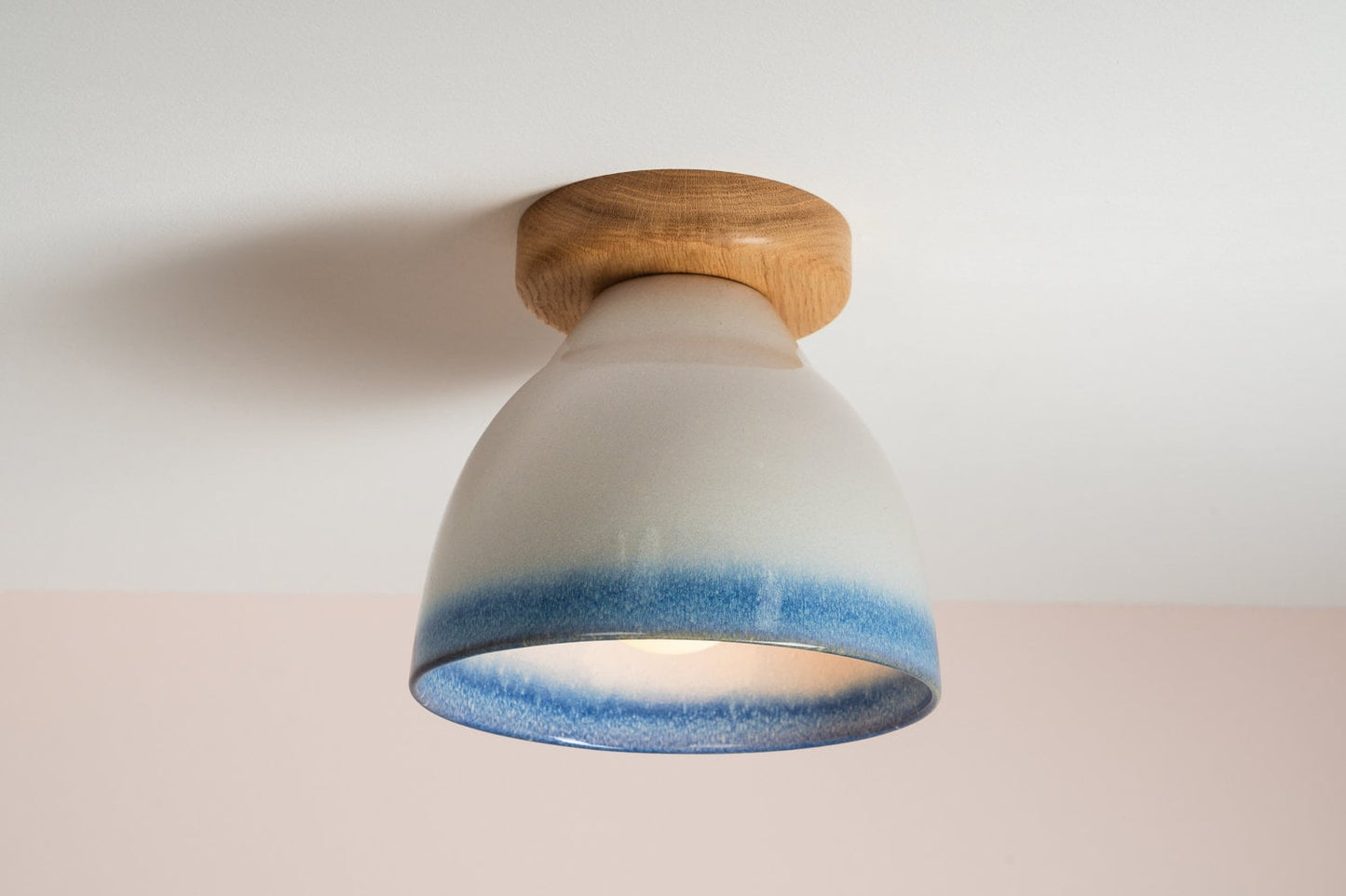Element flush mount ceiling light in ceramic and oak with a blue and white gloss glaze by StudioHaran