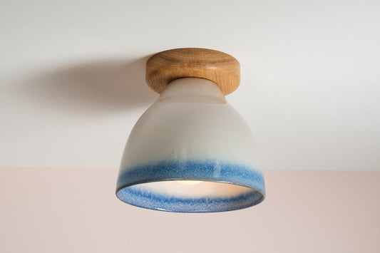 Element flush mount ceiling light in ceramic and oak with a blue and white gloss glaze by StudioHaran