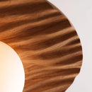 Wooden lampshade with a white light bulb inside on a neutral background