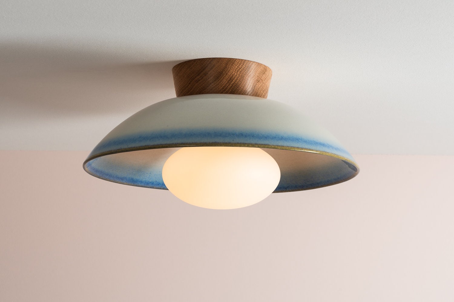 Dawn flush ceiling light in ceramic and oak with a blue and white gloss glaze by StudioHaran