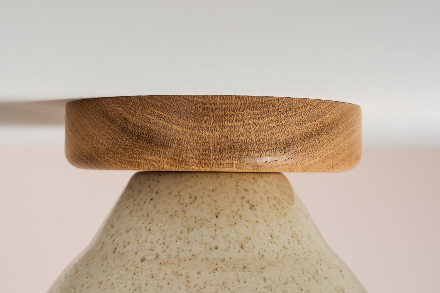 Element flush mount ceiling light in ceramic and oak with a speckled cream glaze by StudioHaran